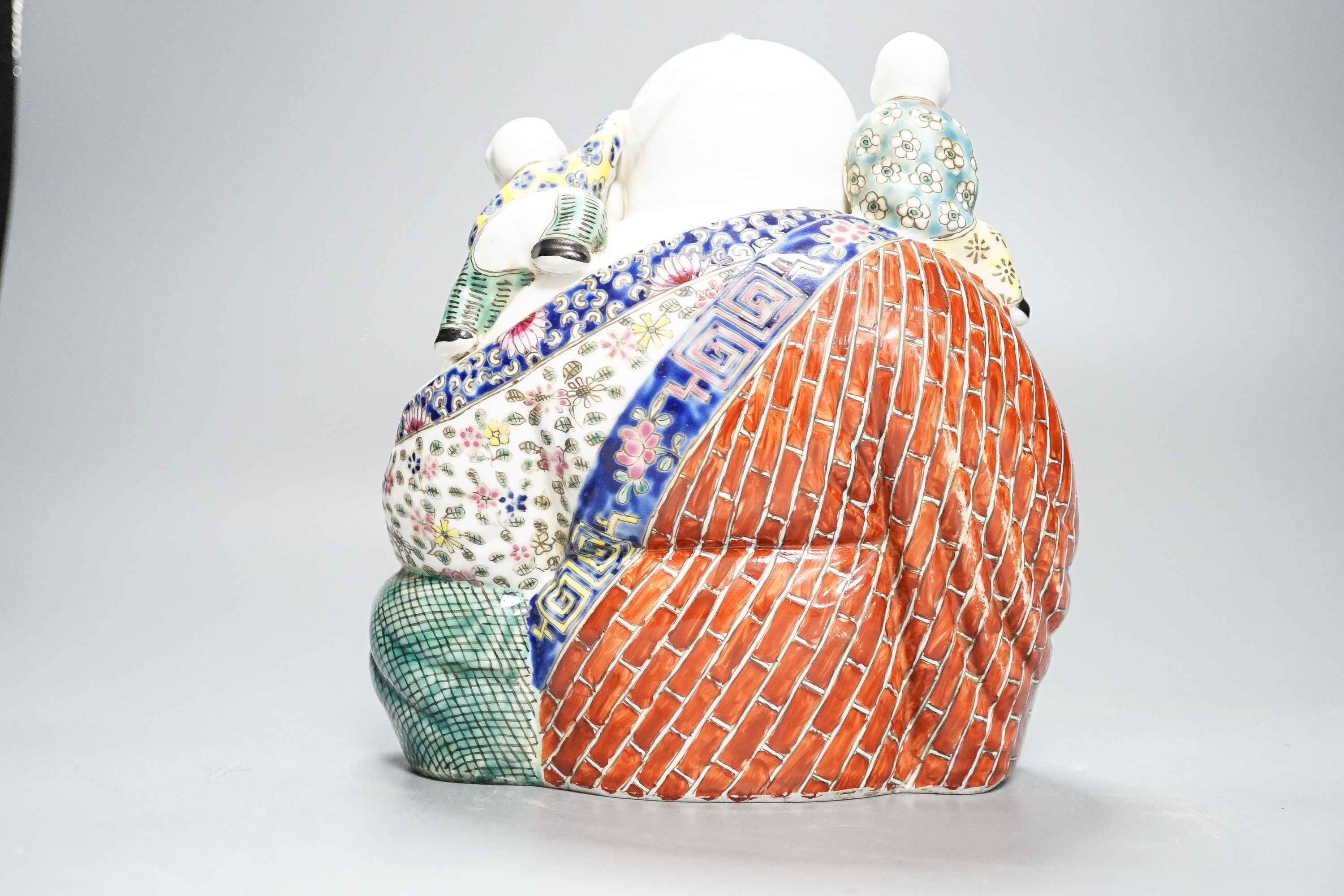 A Chinese enamelled porcelain group of Budai and boys, 19cm high